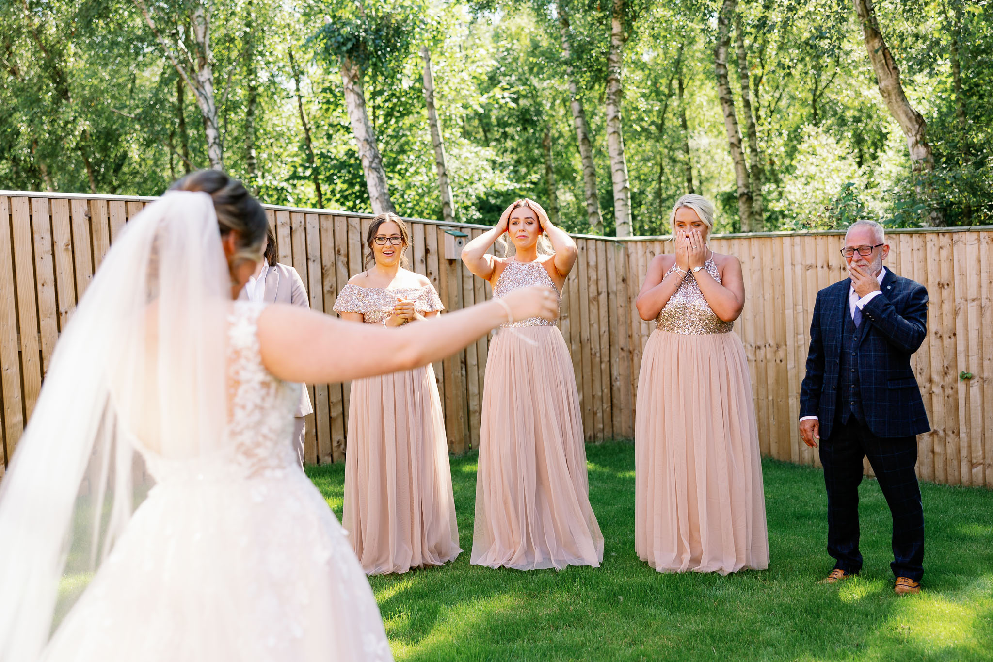 Bridesmaids in blush see bride for first time and cry