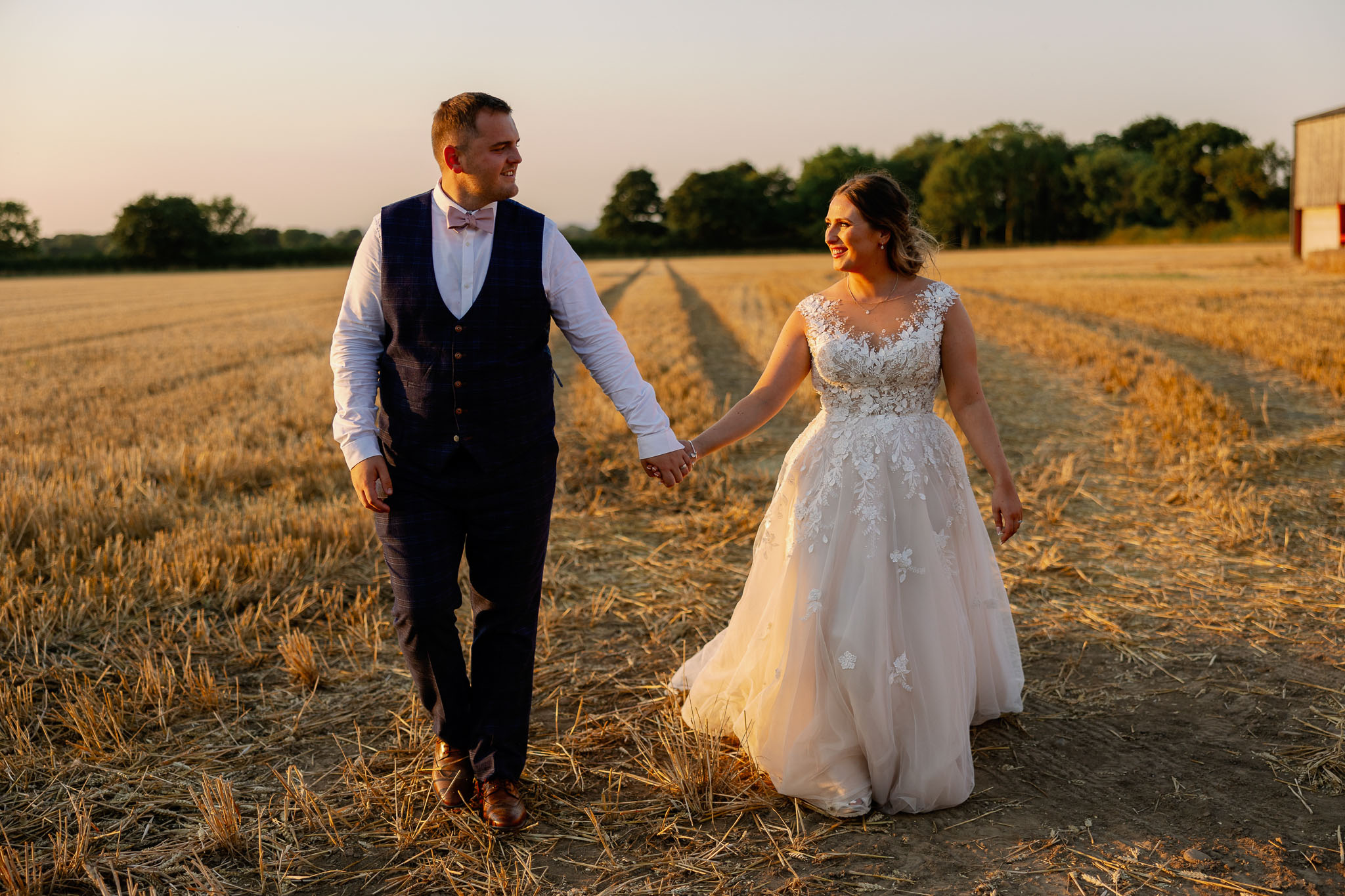 Couple walking at Golden Hour in a wheatfield