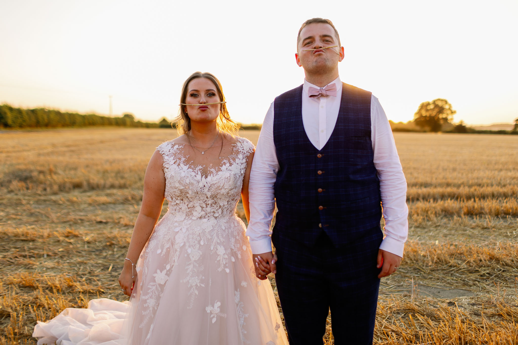 Fun Wedding Pictures of a bride and groom in a corn field