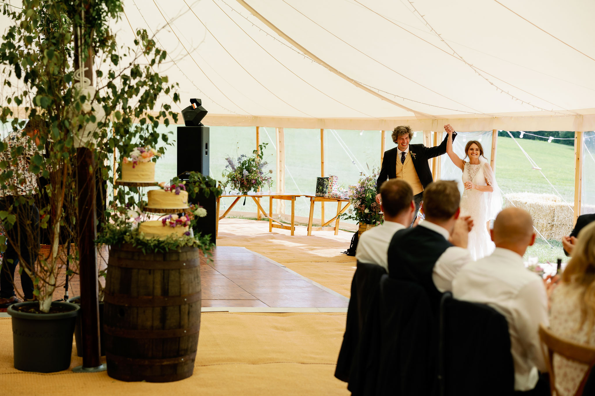 bride and groom entering their Will Marquee tent for a wedding reception 