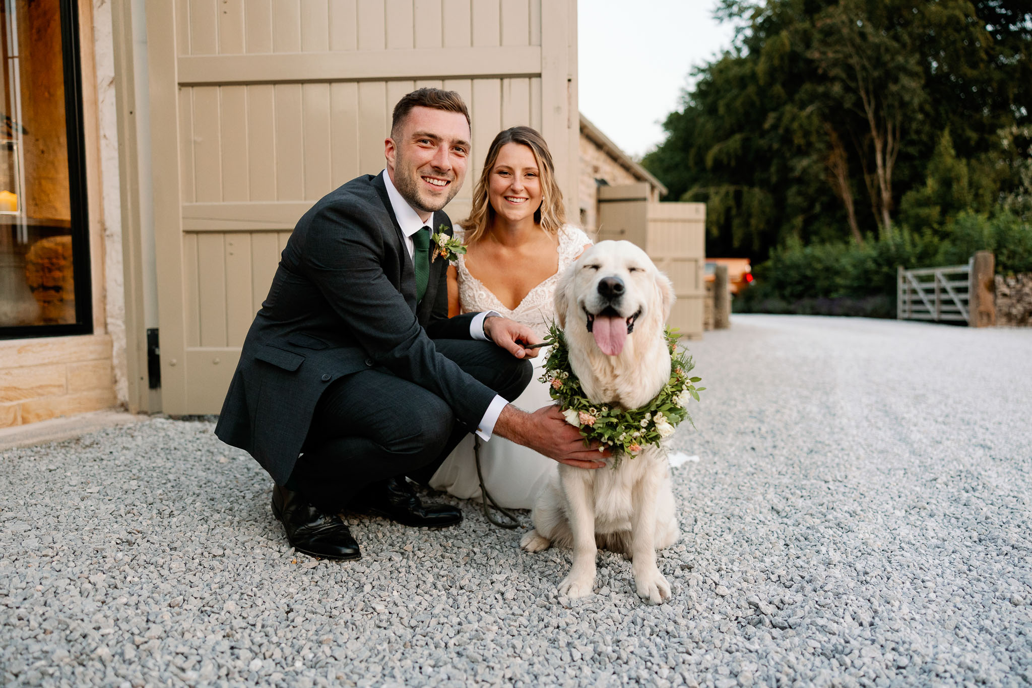 A dog at a wedding wearing a flower garland crown