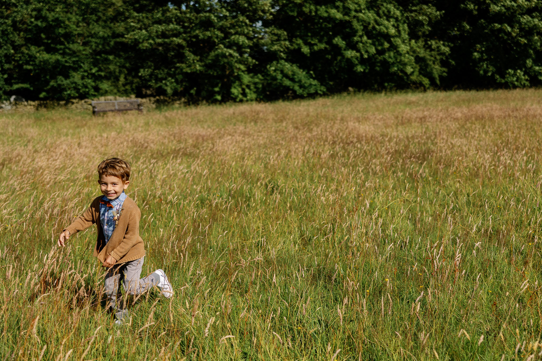 A beautiful page boy running through Yorkshire fields 