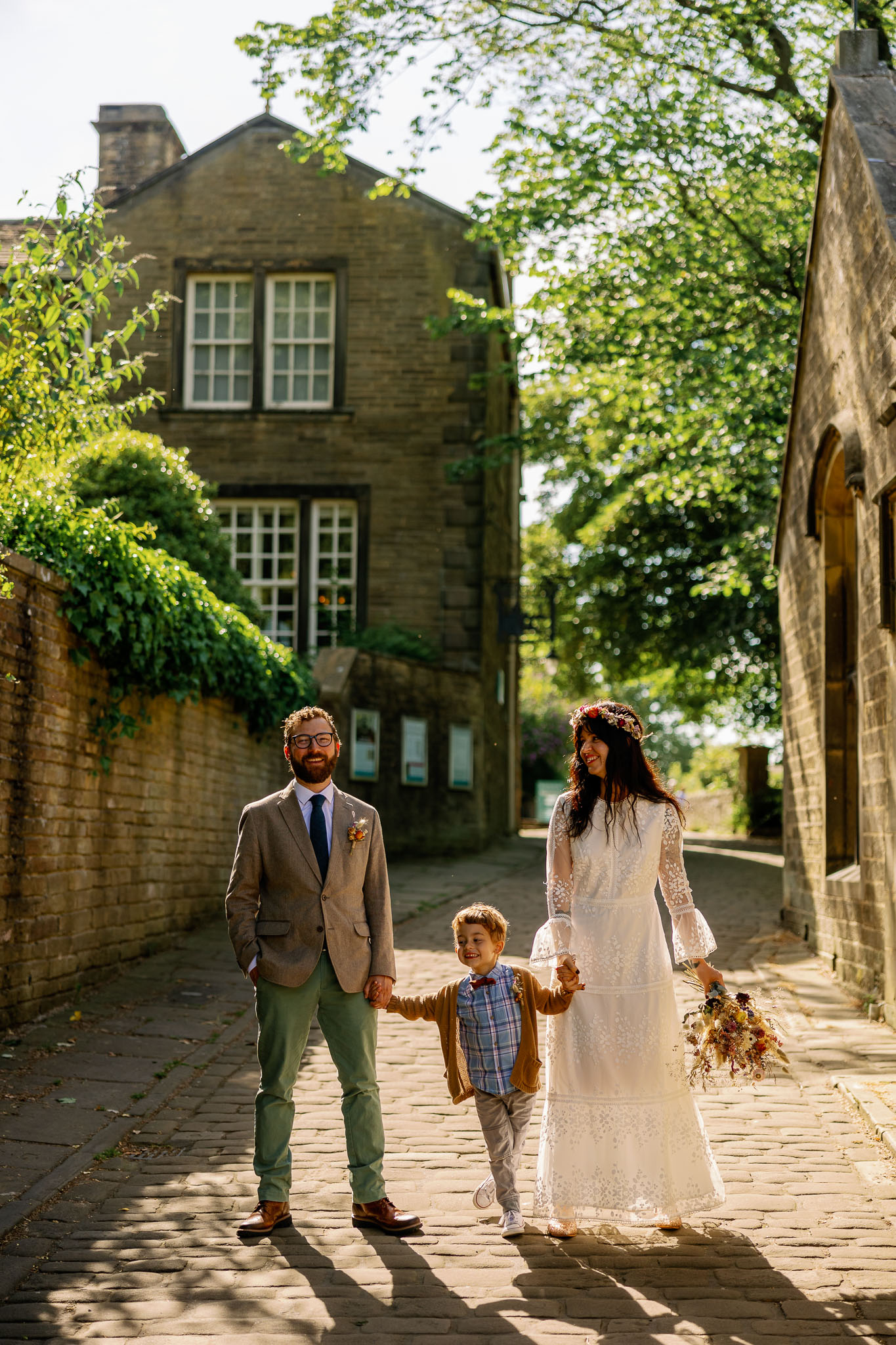 A couple walking with their son at their Haworth Wedding Blessing